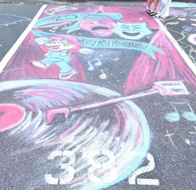 A chalked space with theatre masks, a video-game character, musical notes and a record album