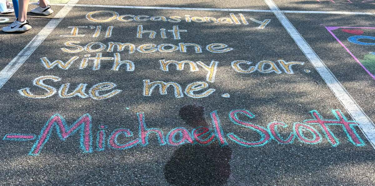 A chalked space quoting Michael Scott - Occasionally I'll hit someone with my car. Sue me.